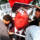Chinese students try to burn a photo depicting Bill Clinton to protest the NATO bombing of the Chinese embassy in Belgrade, near the US embassy in Seoul, May 13, 1999.